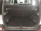 the back of a car with its trunk open and the back seats folded down
