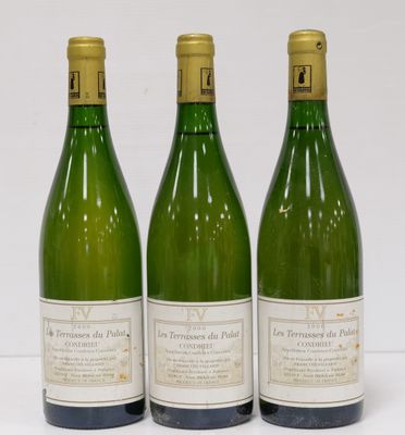 three bottles of wine are lined up on a white surface