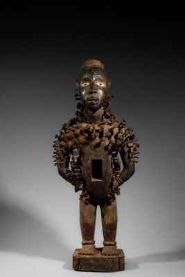 an image of a wooden statue of a man holding a shield