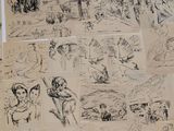 several drawings of people and animals are shown on a table