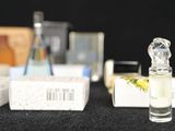 bottles of perfume are lined up on a black surface