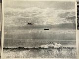 two planes flying over the ocean on a cloudy day