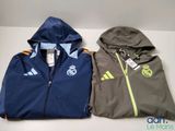 two jackets with hoods on them sitting next to each other