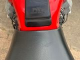 a close up of a red motorcycle with a black seat