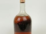 an image of a bottle of liquor sitting on top of a white surface
