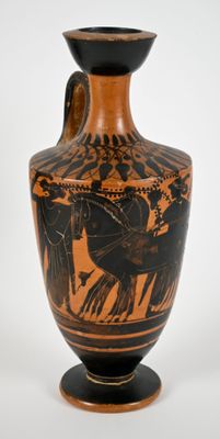 a black and orange vase with a picture of horses on it
