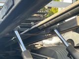 the back end of a truck with a bunch of pipes sticking out of it ' s bed