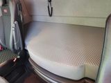 a seat in the back of a van with a mattress on it
