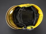 a close up of a yellow hard hat on a black background
