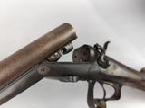 an old gun with a wooden handle on a white background