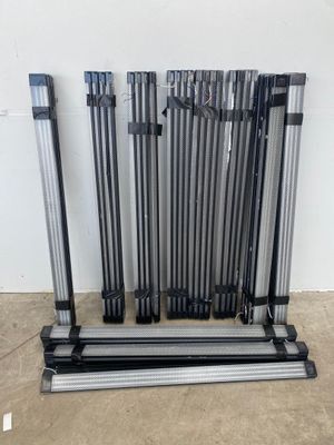 a group of metal poles sitting on top of a floor next to a wall