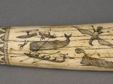 an elephant tooth with drawings on it on a table