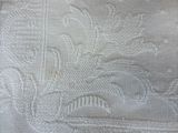 a close up of a bed with a white blanket