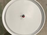 a white bowl with a red knob on it