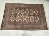 an old rug on the floor with a person standing next to it