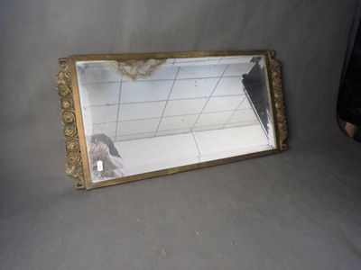 a mirror that is sitting on the ground with a person taking a picture