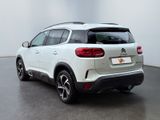 the rear end of a white citrole parked in a room