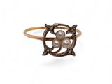 a close up of a gold ring with pearls on it