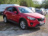 the red mazda cx - 5 is parked in a parking lot