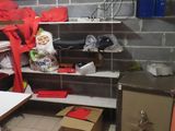 a small room with a lot of stuff on the shelves