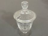 a clear glass jar with a lid on a table