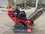une machine rouge qui est à l'arrêt dans la boue