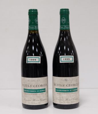 two bottles of red wine sitting next to each other on a table