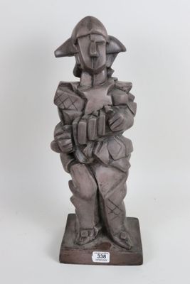 statue of a man with a hat and a jacket on a base