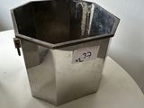 a metal container sitting on top of a white table