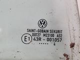 a close up of a volkswagen logo on the side of a car