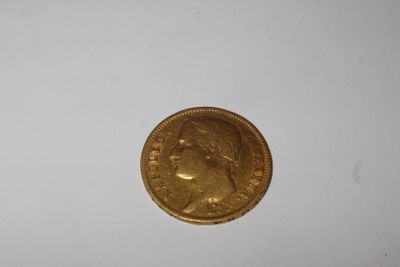 a close up of a gold coin on a white surface