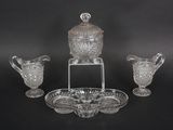 three pieces of glass on a stand and a bowl