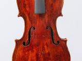 an old violin with a bow hanging from it ' s back