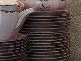 a stack of dishes and cups on a table