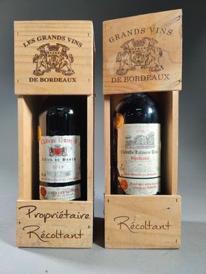 two bottles of wine in wooden boxes with labels on them