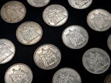 a lot of coins that are on a black surface