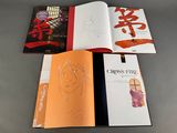 three books are sitting on a table next to each other