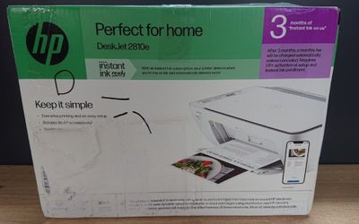 the box of the printer is open on the table