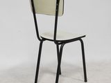 black and white chair against a white wall against a white wall