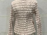 cream ruffled jacket on a mannequin dummy