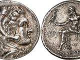 a silver coin with an image of a man and a woman on it