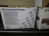 two boxes of gc investment powder sitting on a counter