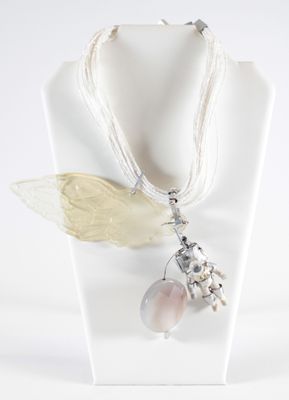 a necklace that has a butterfly on it and a flower on it