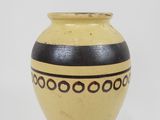 yellow and black vase on white background with black and white design