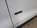 a close up of a white refrigerator with a sticker on the door