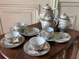 a table with a bunch of tea cups and saucers on it
