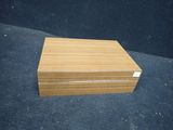 a wooden box sitting on top of a black surface