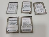 four hard drives sitting on top of a white table next to each other