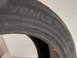 a close up of a tire on a white wall