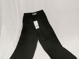 a pair of black pants sitting on top of a white sheet